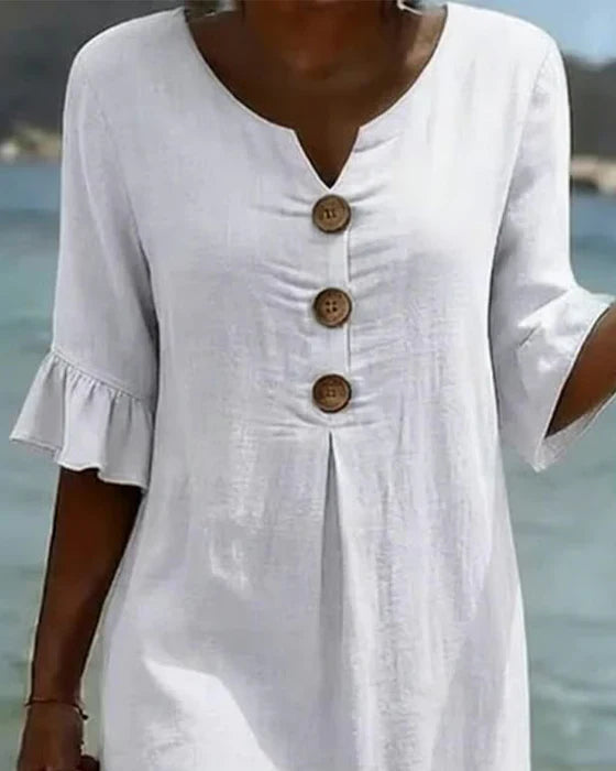 White summer dress featuring ruffled sleeves, made from a soft cotton-linen blend, perfect for warm weather outings and casual occasions. 2