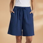 Women's relaxed fit knee-length shorts in a stylish design, perfect for casual outings and summer wear. 15