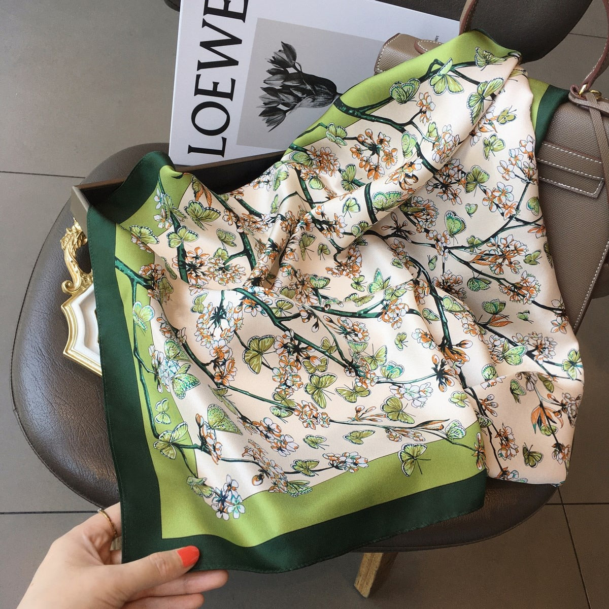 Women's square silk scarf featuring a luxurious design, ideal for versatile styling and elegant occasions, showcasing vibrant colors and a smooth texture. 4