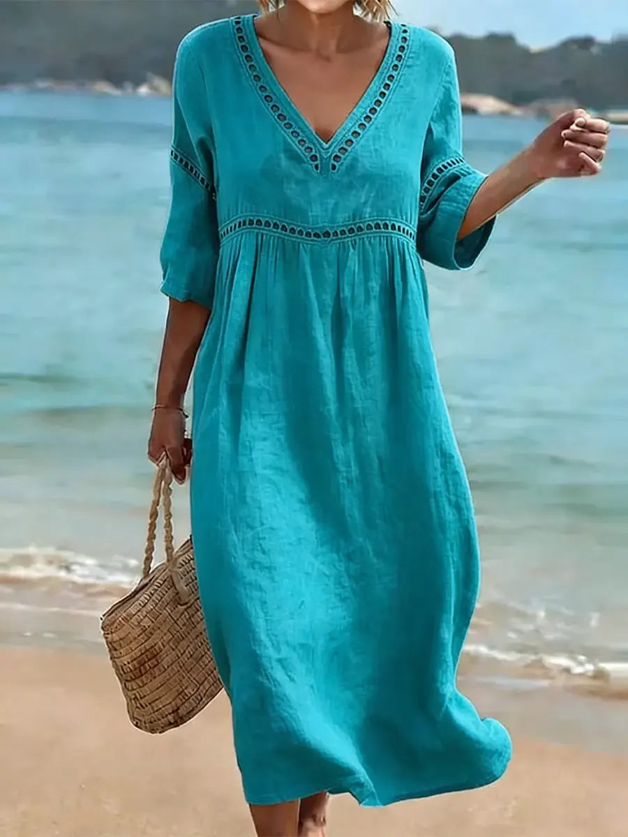 Women's summer V-neck cotton dress featuring a flowy casual style and convenient side pockets, perfect for warm weather outings. 3